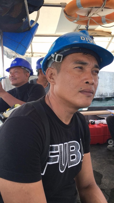 Crew member portrait wearing blue DIVER helmet