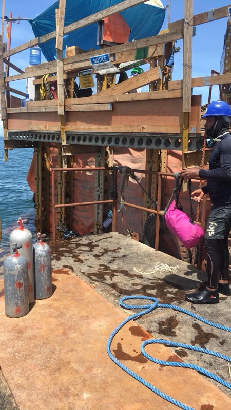 Dive platform with scuba tanks, diver prepping equipment