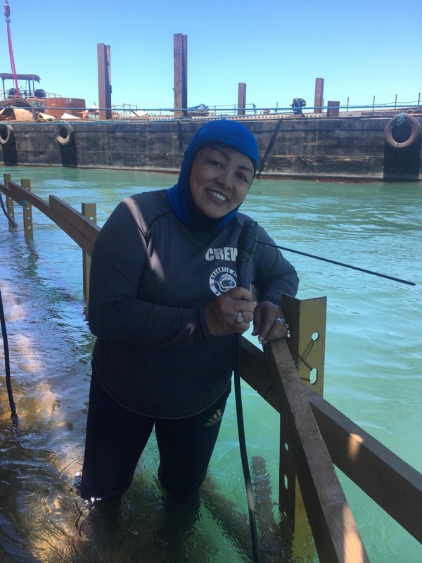 Smiling female crew member in the water
