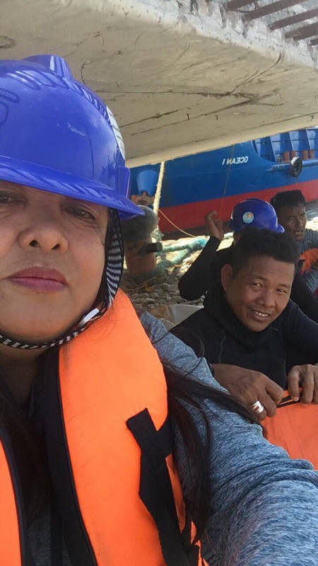 Two crew members working under bridge structure